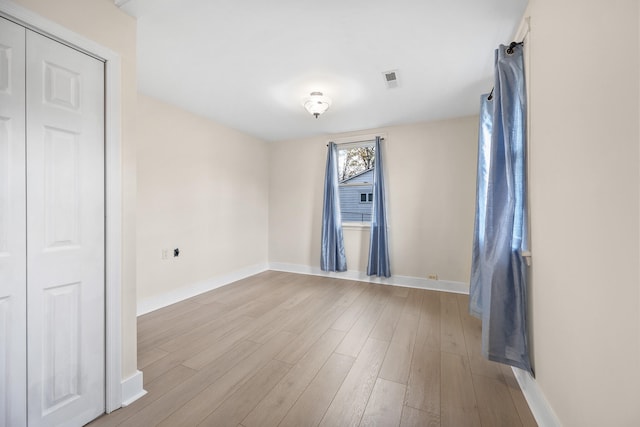 unfurnished room with light hardwood / wood-style floors