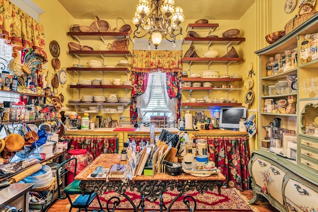 misc room with hardwood / wood-style floors and a notable chandelier