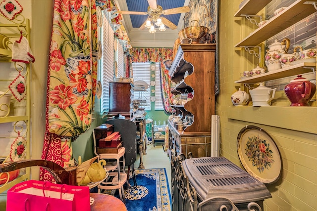 interior space featuring ceiling fan and ornamental molding