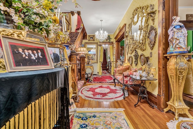 dining area with wood-type flooring and a notable chandelier