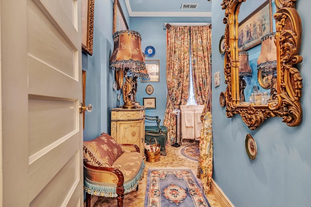 living area featuring ornamental molding