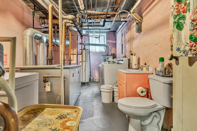 bathroom featuring independent washer and dryer, concrete floors, and toilet