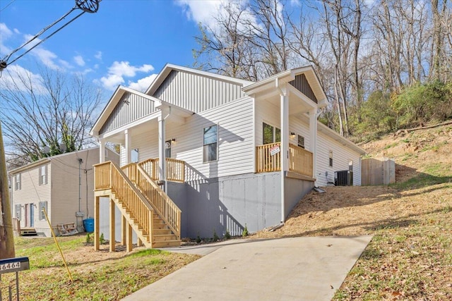 view of property exterior with central air condition unit and a porch