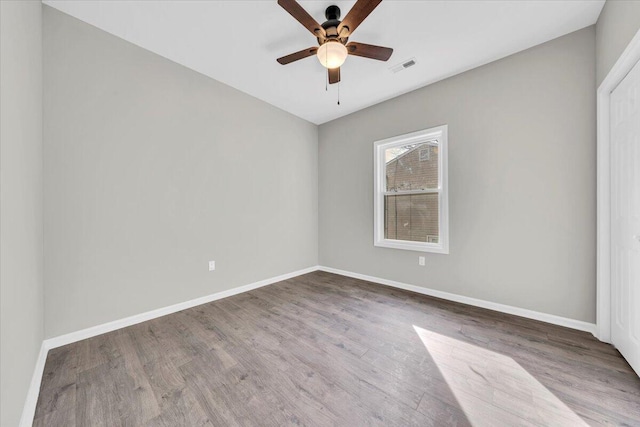 spare room with ceiling fan and wood-type flooring