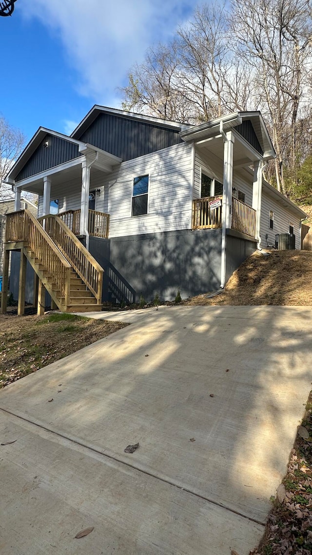 view of property exterior with cooling unit and covered porch