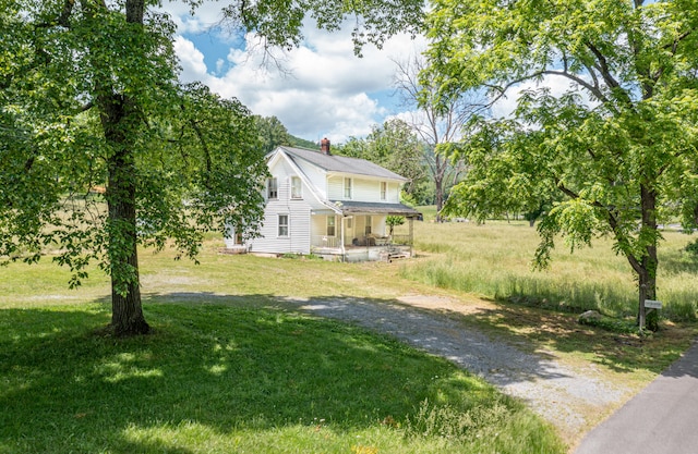 view of front facade with covered porch and a front yard