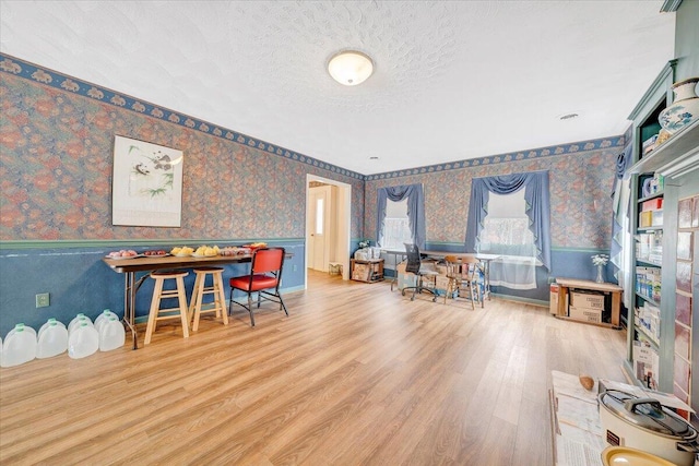 playroom featuring hardwood / wood-style floors and a textured ceiling