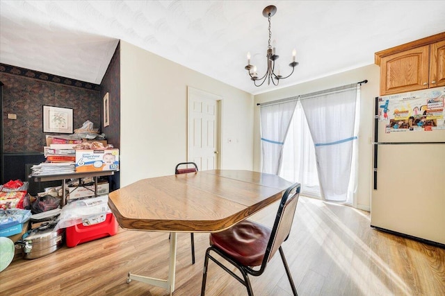 dining space with an inviting chandelier and light wood-type flooring