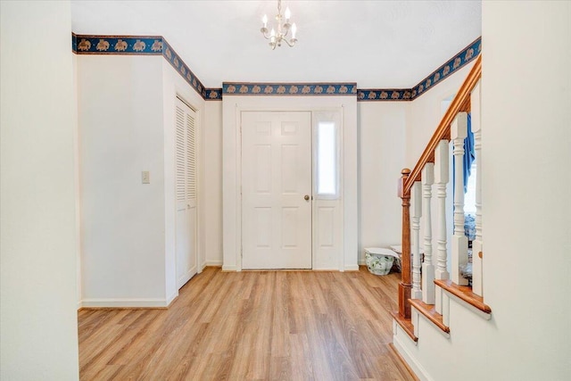 foyer featuring hardwood / wood-style flooring and a chandelier