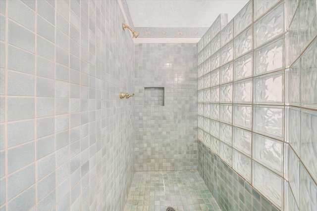 bathroom with a tile shower