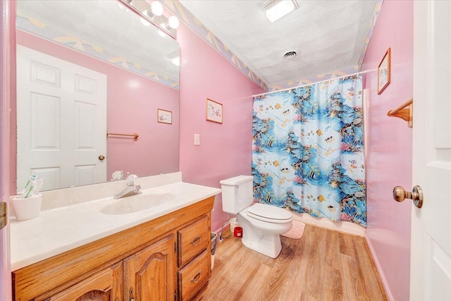 full bathroom featuring vanity, hardwood / wood-style floors, toilet, and shower / bathtub combination with curtain