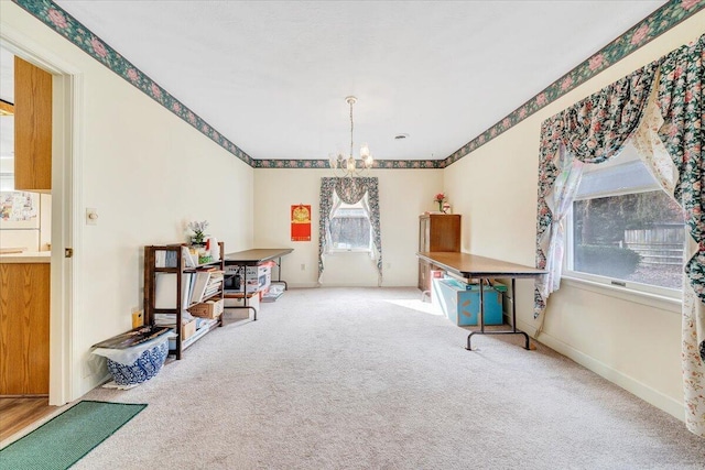 miscellaneous room featuring carpet flooring and a notable chandelier