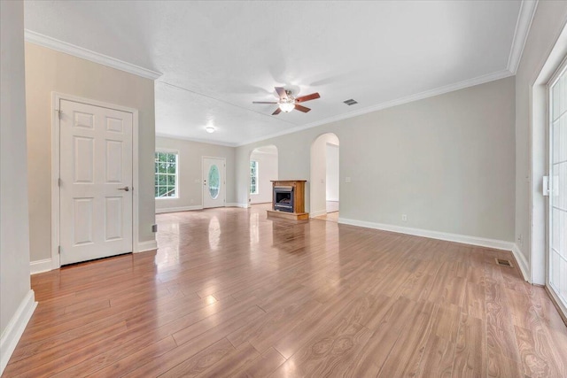 unfurnished living room with ceiling fan, light wood-type flooring, and crown molding