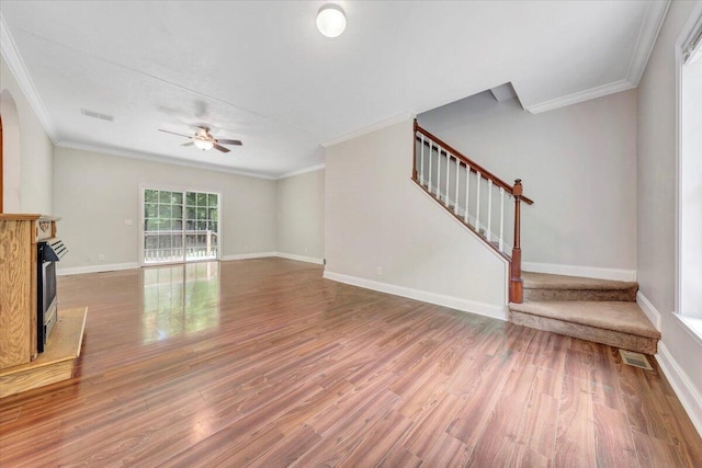 unfurnished living room with ceiling fan, wood-type flooring, and crown molding