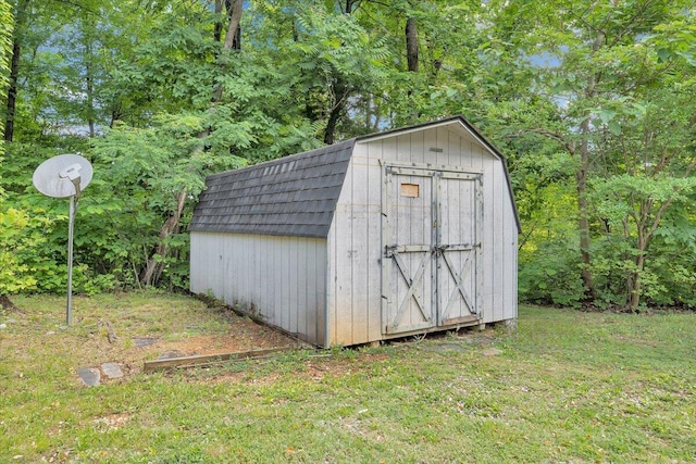 view of outbuilding featuring a lawn