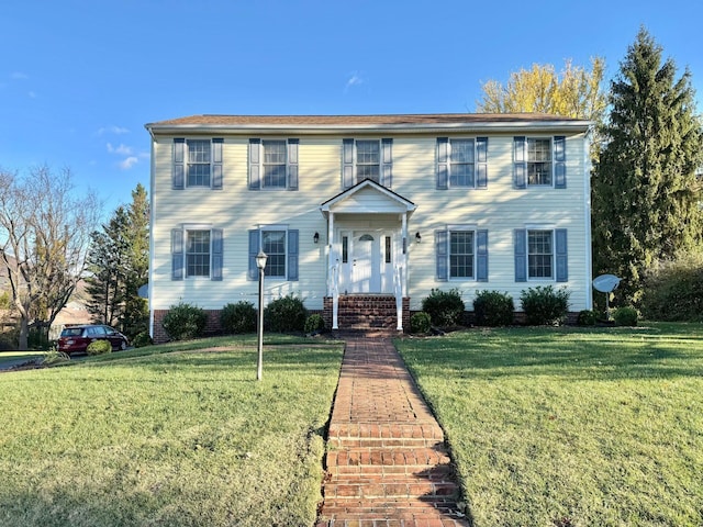 colonial-style house featuring a front lawn