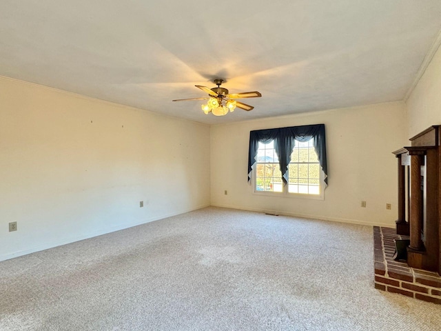 unfurnished living room featuring carpet, ceiling fan, and crown molding