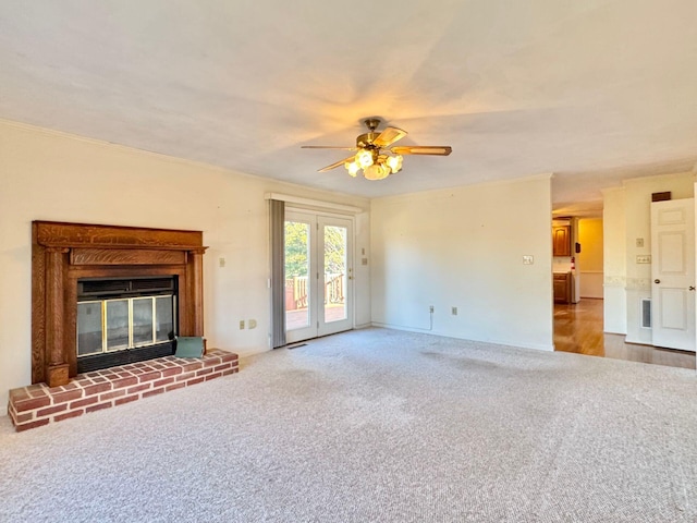 unfurnished living room with a fireplace, wood-type flooring, and ceiling fan