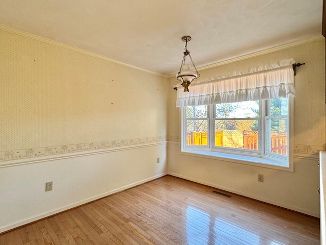 spare room with hardwood / wood-style floors and ornamental molding