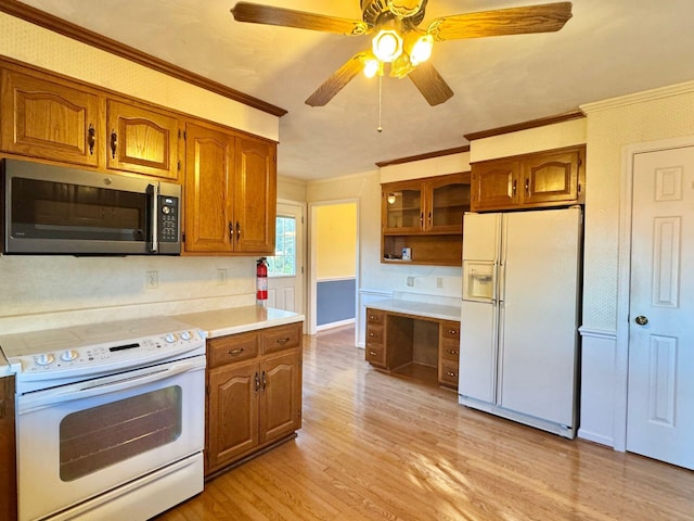 kitchen featuring white appliances, light hardwood / wood-style flooring, ceiling fan, and ornamental molding