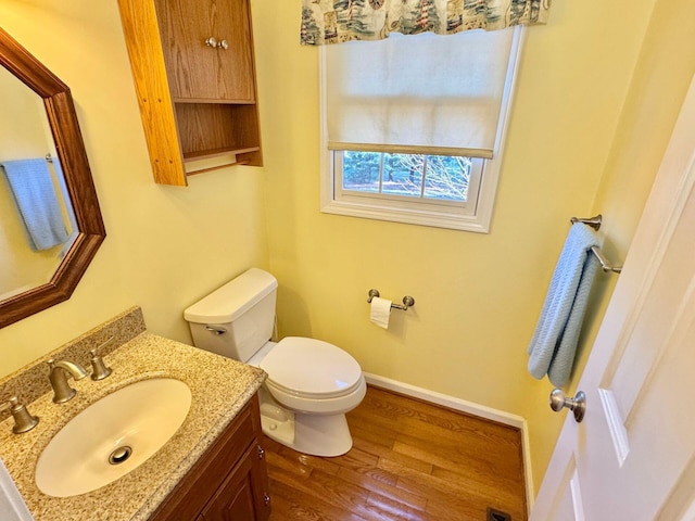 bathroom with vanity, wood-type flooring, and toilet