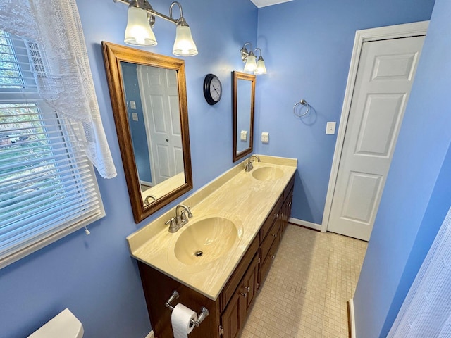 bathroom with tile patterned floors, vanity, and toilet