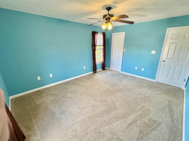 unfurnished bedroom featuring ceiling fan and carpet floors