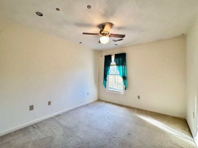 unfurnished room featuring light carpet and ceiling fan