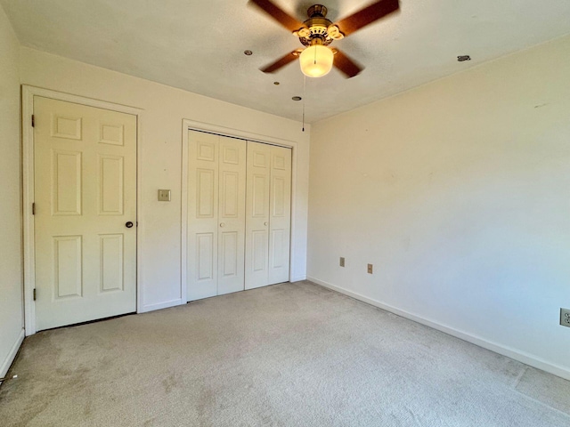 unfurnished bedroom featuring ceiling fan and light colored carpet