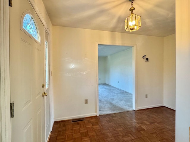 entrance foyer featuring dark parquet floors