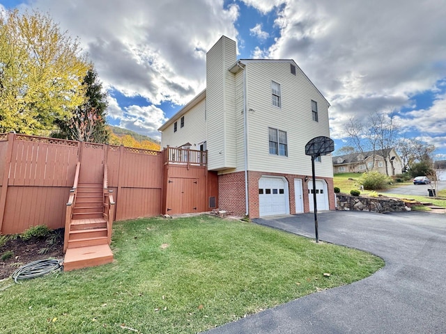 view of property exterior with a garage and a yard