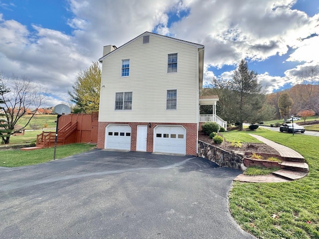 view of property exterior with a yard and a garage