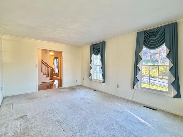 carpeted spare room with crown molding