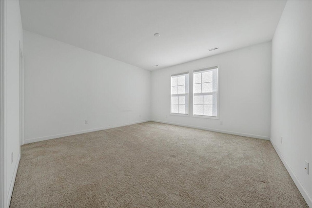 unfurnished room with light carpet