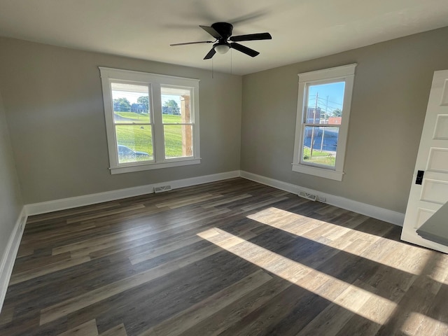 spare room featuring dark hardwood / wood-style floors and ceiling fan