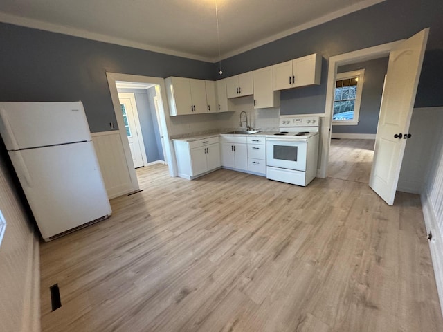 kitchen featuring sink, white cabinets, white appliances, and light wood-type flooring