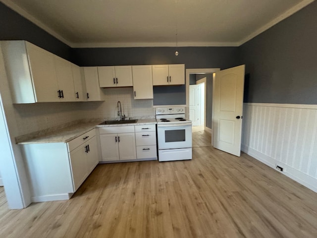 kitchen with white range with electric cooktop, light hardwood / wood-style flooring, white cabinets, and sink