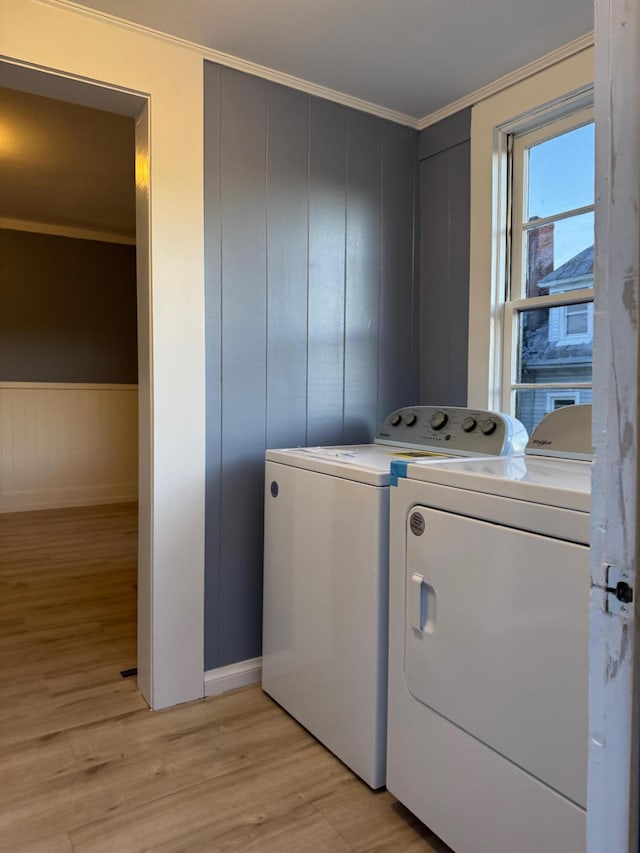 laundry room featuring light hardwood / wood-style floors, independent washer and dryer, and ornamental molding