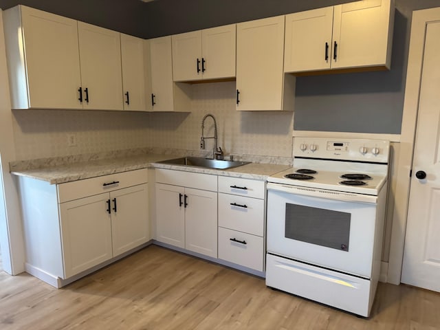 kitchen with backsplash, sink, light wood-type flooring, white electric range oven, and white cabinetry