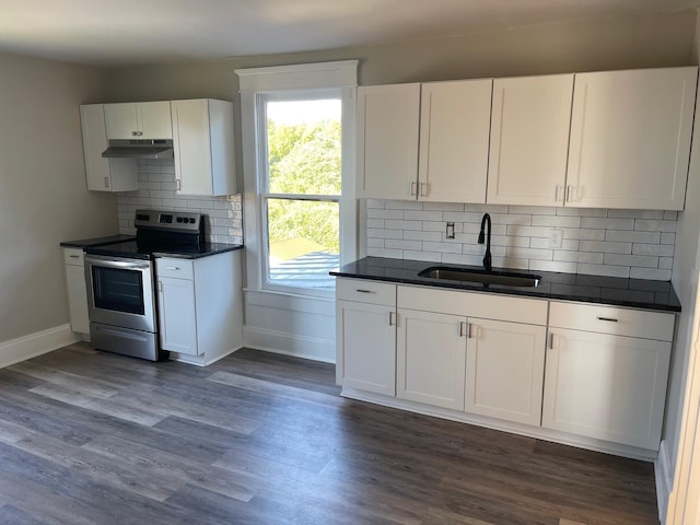 kitchen with stainless steel range with electric stovetop, dark wood-type flooring, sink, decorative backsplash, and white cabinetry