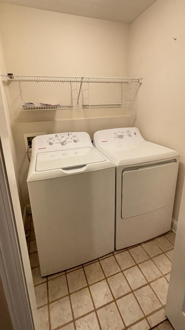 clothes washing area with independent washer and dryer