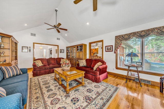 living room with light hardwood / wood-style floors and lofted ceiling