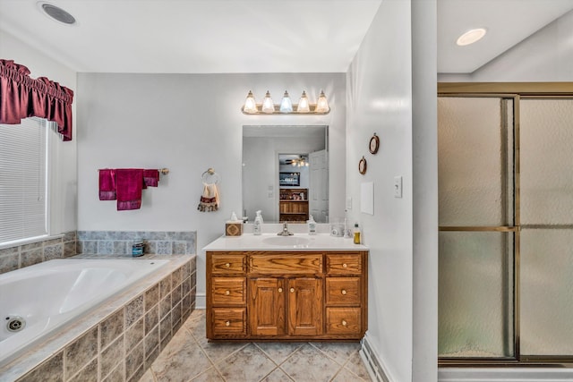 bathroom with tile patterned floors, ceiling fan, vanity, and shower with separate bathtub