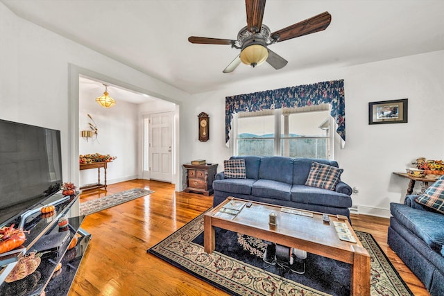 living room with ceiling fan and wood-type flooring