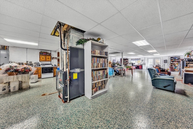 basement featuring a paneled ceiling and electric panel