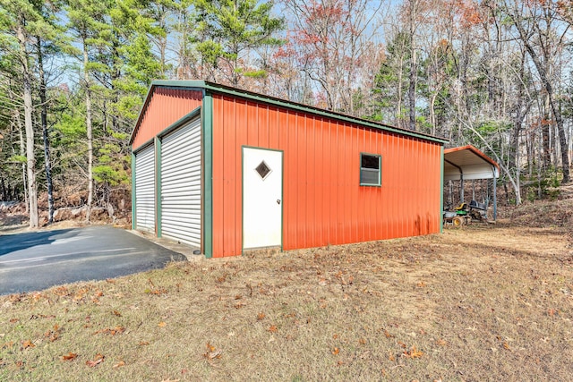 view of outbuilding featuring a carport and a garage