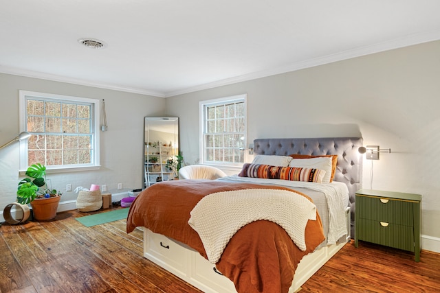 bedroom featuring multiple windows, crown molding, and dark hardwood / wood-style flooring