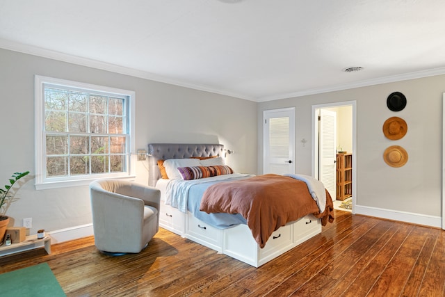 bedroom with hardwood / wood-style flooring and crown molding