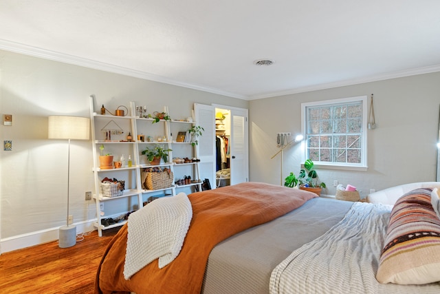 bedroom featuring hardwood / wood-style floors and crown molding