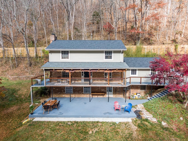 back of house featuring a patio area and a yard